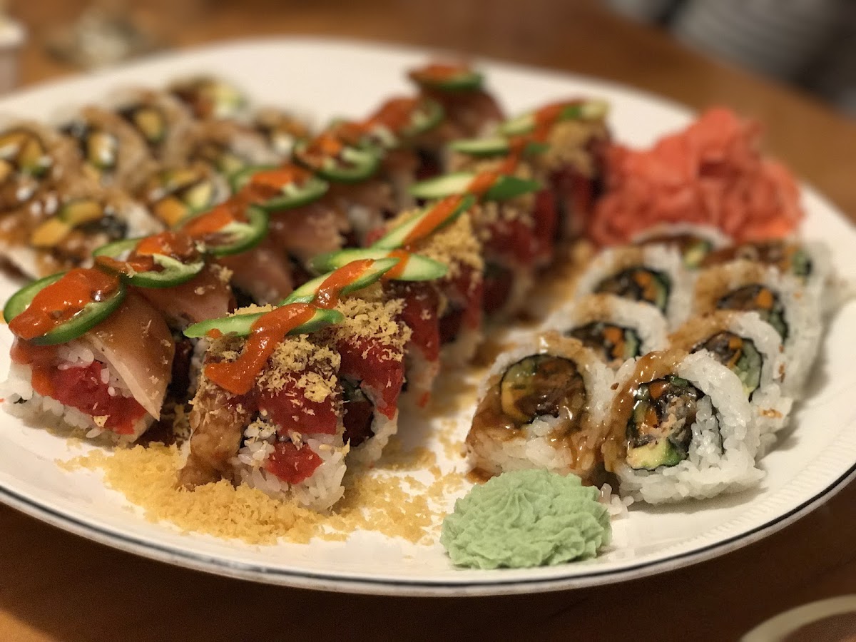 A vibrant platter of Ozeki specialty rolls with ginger and wasabi