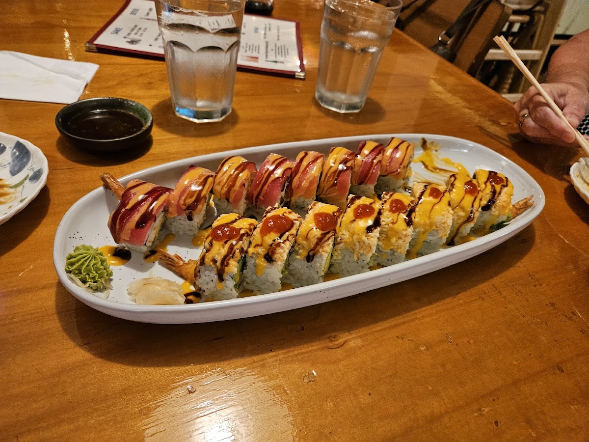 A long sushi boat being shared at the table at Ozeki Japanese Restaurant