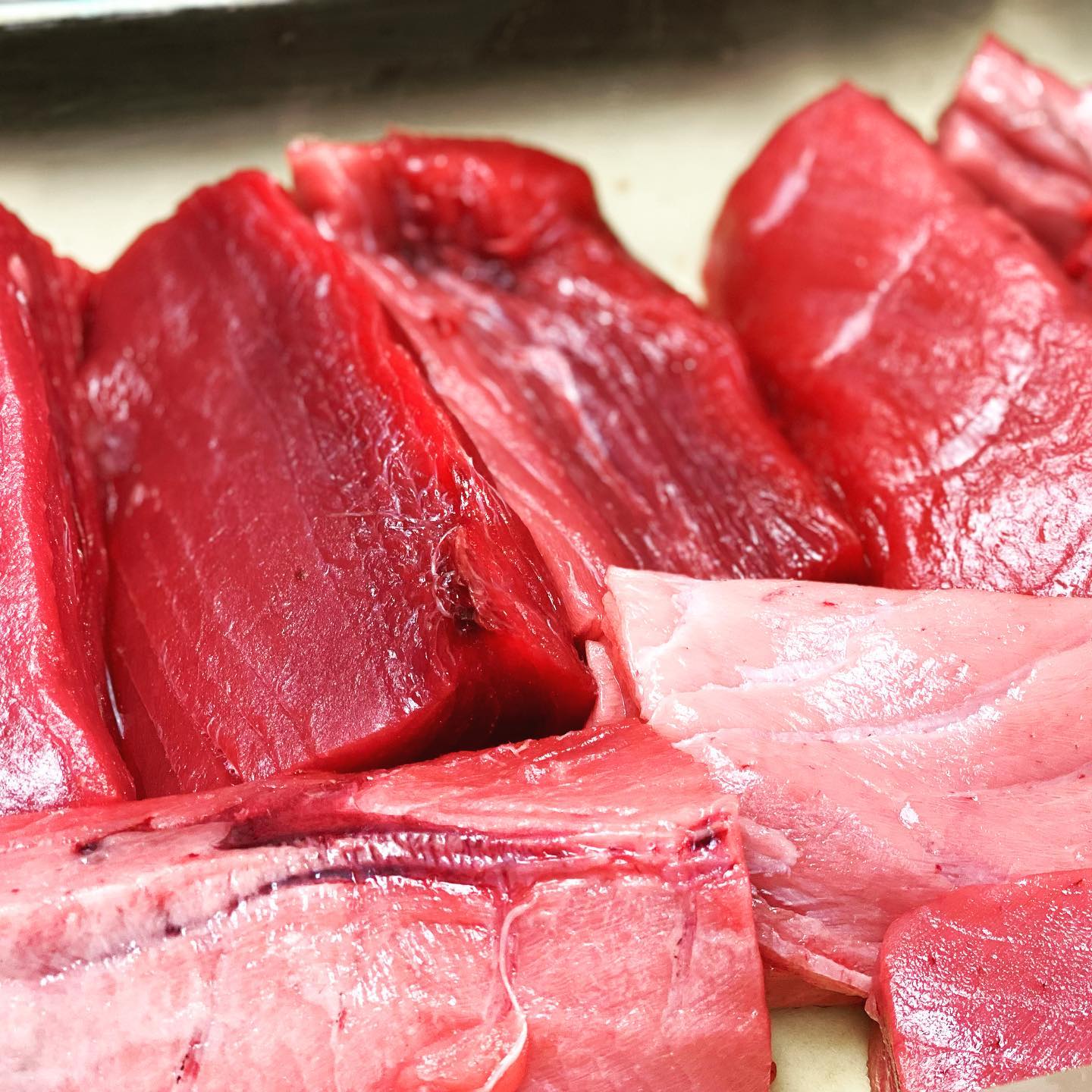 Sashimi-grade tuna being sliced fresh in the Ozeki kitchen